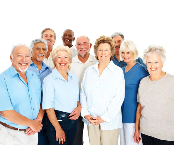 A cheerful group of eleven older adults, smiling together.